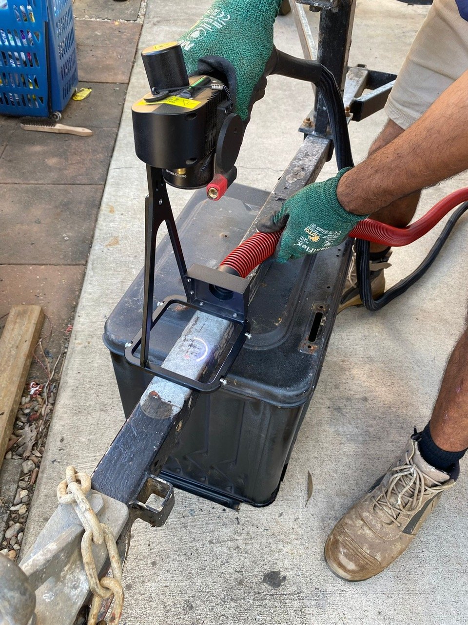 Vacuum hose capturing debris at the laser head